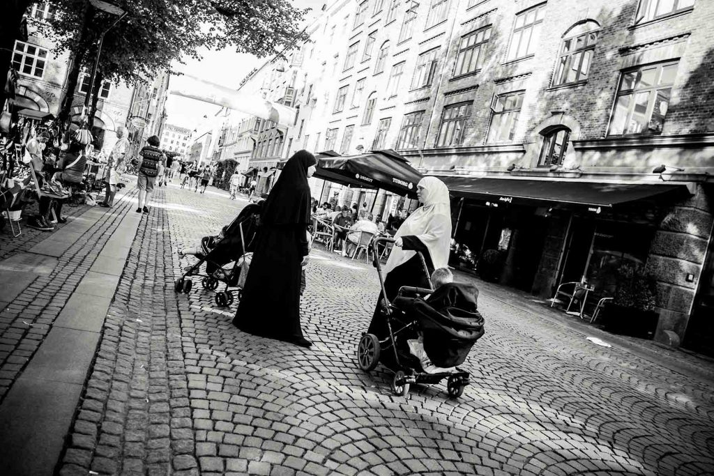 Two women talking at the Norrebro's neighborhood in Copenhagen, Denmark on June, 2016. Norrebro is the neighborhood where the author of the attacks of Copenahgen Omar  Abdel Hamid El-Hussein was shot down in 2015.