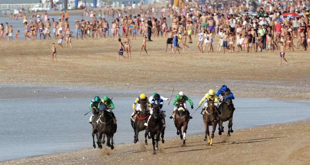 Jockeys race along the beach during the traditional beach race on the Sanlucar de Barrameda's beach in southern Spain, on August 10, 2011. Sanlucar horse racing dates back to 1845 and is some of the oldest in Europe, it currently takes place near the mouth of the Rio Guadalquivir several times during the month of August. (AP Photo/Miguel Gomez)