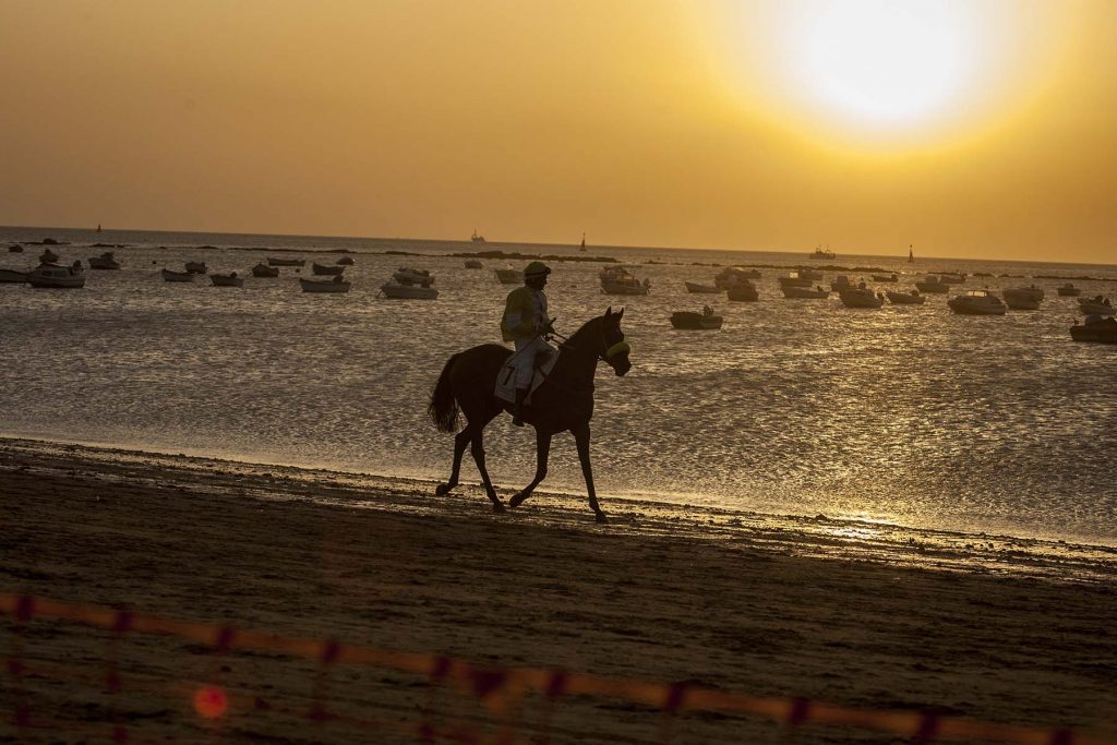 Jockeys race along the beach during the traditional beach race on the Sanlucar de Barrameda's beach in southern Spain, on August 10, 2011. Sanlucar horse racing dates back to 1845 and is some of the oldest in Europe, it currently takes place near the mouth of the Rio Guadalquivir several times during the month of August. (AP Photo/Miguel Gomez)