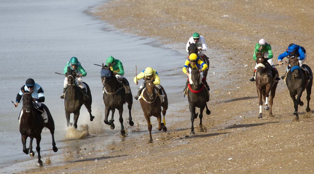 Jockeys race along the beach during the traditional beach race on the Sanlucar de Barrameda's beach in southern Spain, on August 10, 2011. Sanlucar horse racing dates back to 1845 and is some of the oldest in Europe, it currently takes place near the mouth of the Rio Guadalquivir several times during the month of August. (AP Photo/Miguel Gomez)