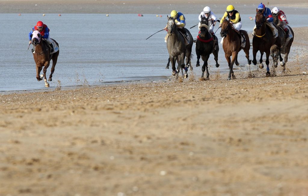 Jockeys race along the beach during the traditional beach race on the Sanlucar de Barrameda's beach in southern Spain, on August 10, 2011. Sanlucar horse racing dates back to 1845 and is some of the oldest in Europe, it currently takes place near the mouth of the Rio Guadalquivir several times during the month of August. (AP Photo/Miguel Gomez)