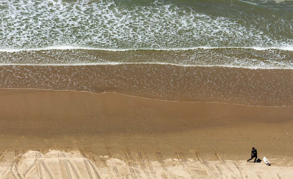 surfer stretching on the beach