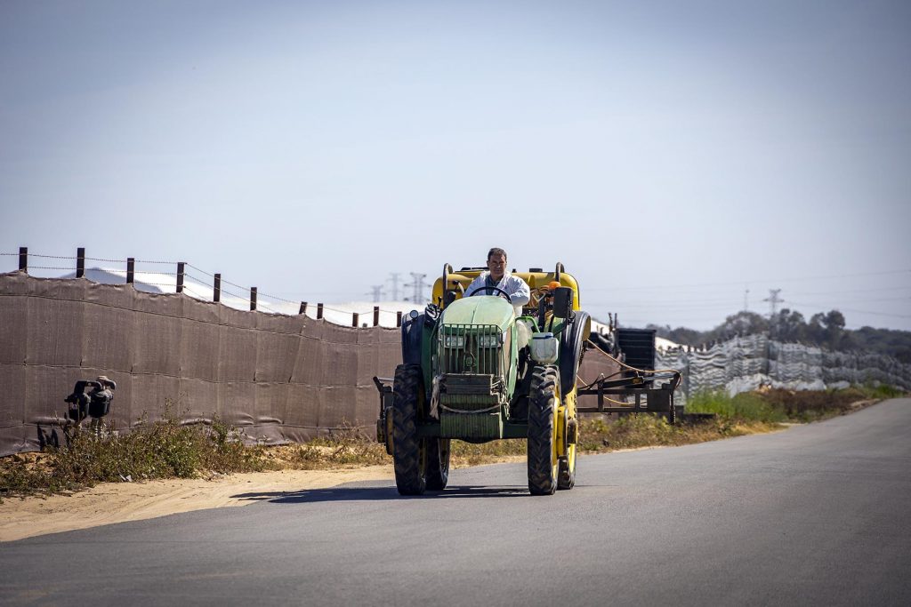 Donana, drought and heat. A man on a tractor drives past the fences of the greenhouses near  to the Donana’s National Park in Huelva, southern Spain on Friday, May 5 in 2023. NRC Photo//Miguel Gomez