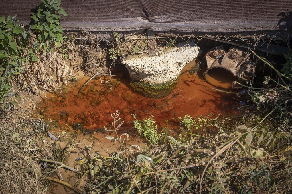 Donana, drought and heat. Spillage of water with traces of chemicals next to the fence of one of the greenhouses near  to the Donana’s National Park in Huelva, southern Spain on Friday, May 5 in 2023. NRC Photo//Miguel Gomez